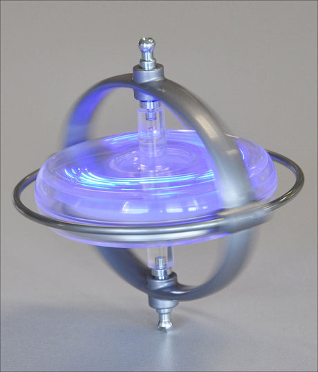 Kleines Gerät mit Metallrahmen, blauer LED-Beleuchtung, auf einer glatten Oberfläche.