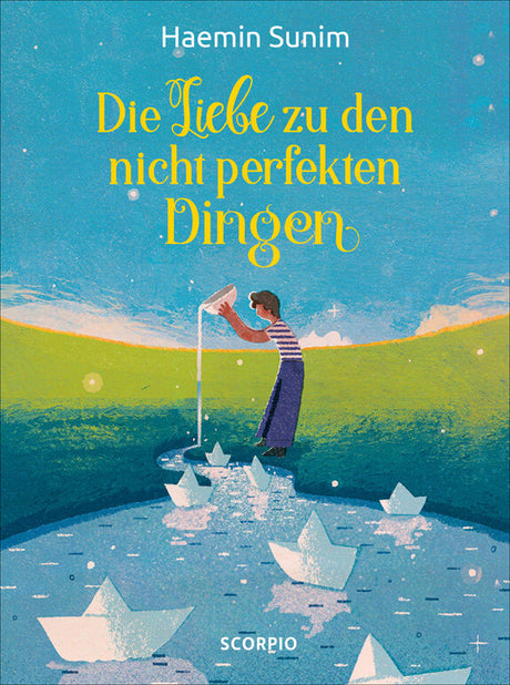 Buchcover mit einem Jungen, der Papierboote in einem Fluss mit grüner Wiese im Hintergrund baut.