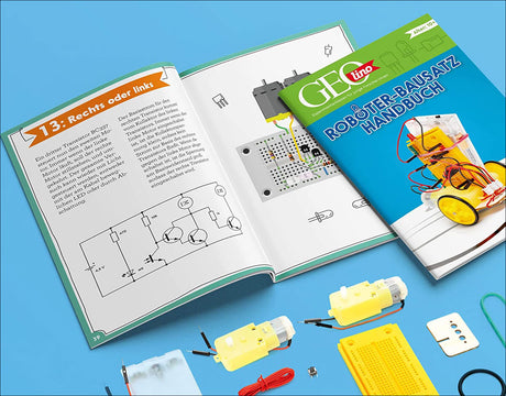 Offenes Roboter-Bausatz-Handbuch mit elektronischen Komponenten und Schaltplänen auf blauer Oberfläche.