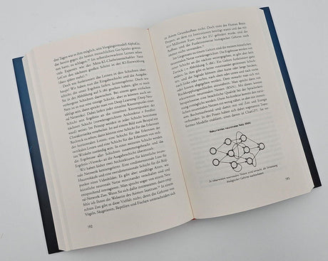 Offenes Buch mit Text und Diagramm über rekurrente neuronale Netze (RNN).